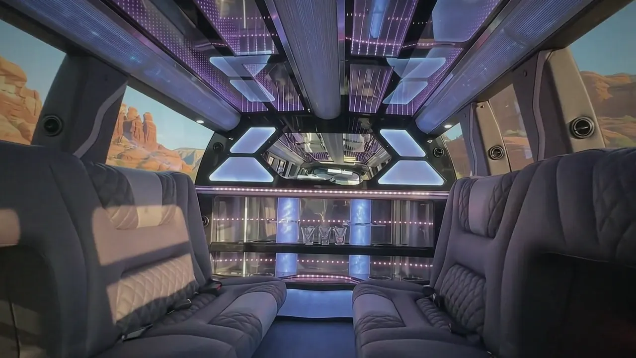 Inside the Cadillac Escalade limo in Loveland: LED light-show ceiling, leather lounge seating and lit bar